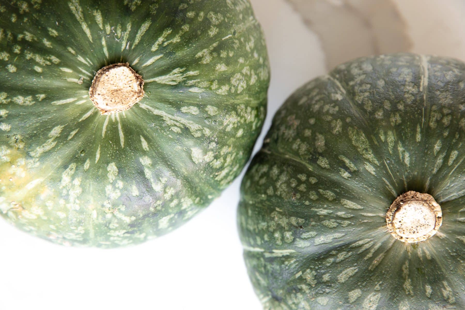 Two whole kabocha squash.