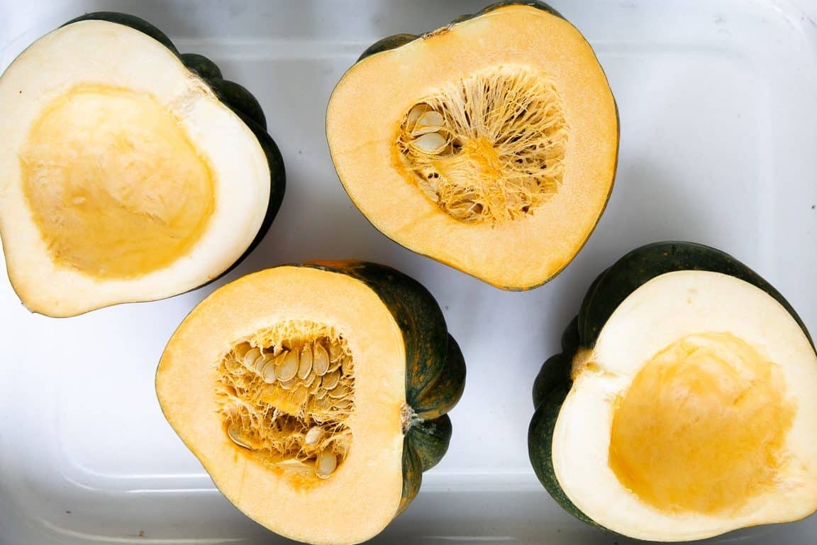 Image of two acorn squash that have been cut in half.
