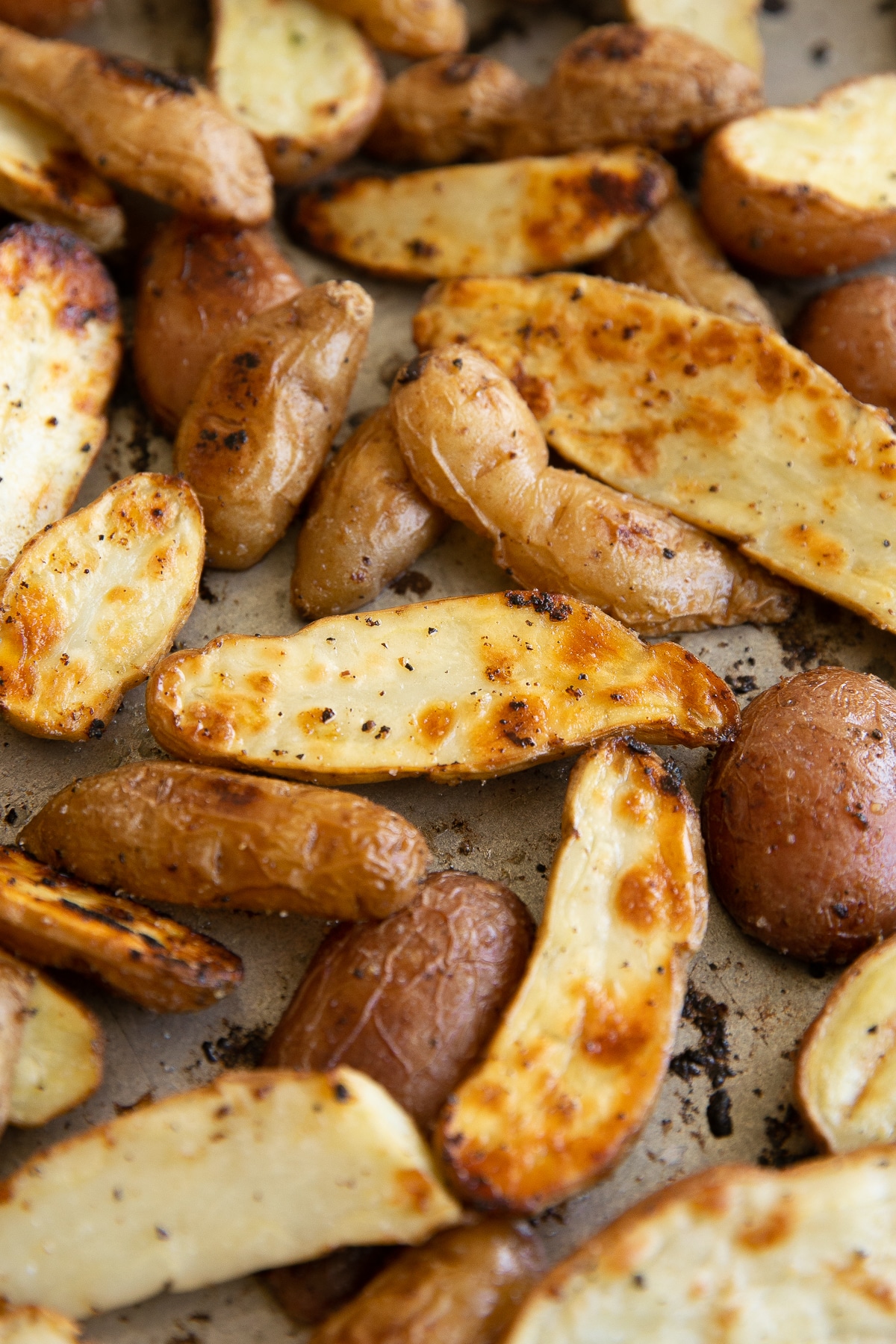 Roasted fingerling potatoes on a large baking sheet.