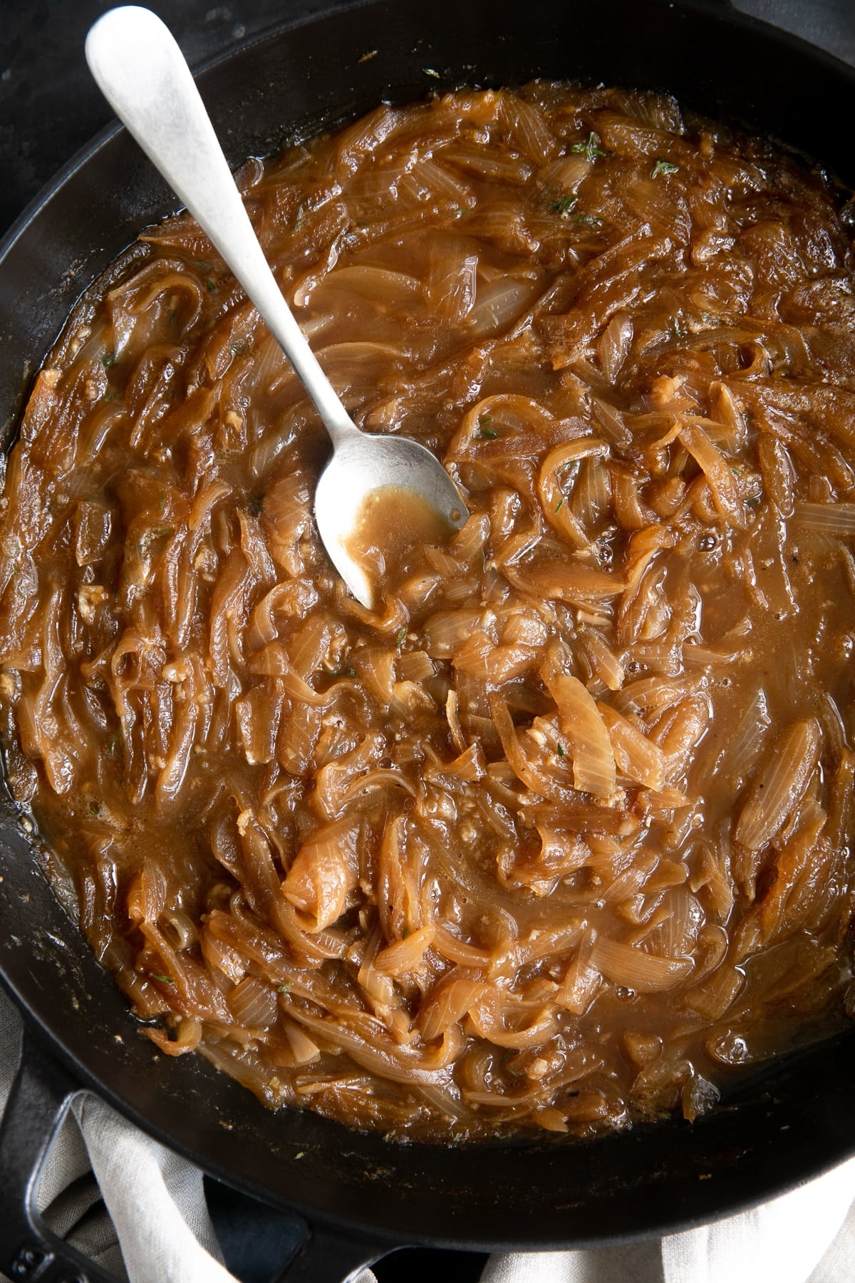 Caramelized onions and broth in a large skillet.