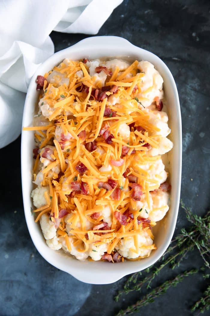 Blanched cauliflower tossed in homemade cheese sauce and topped with shredded cheese and bacon.