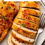 Sliced chicken breast with browned seasoned crust, labeled “Perfect Air Fryer Chicken Breasts.”