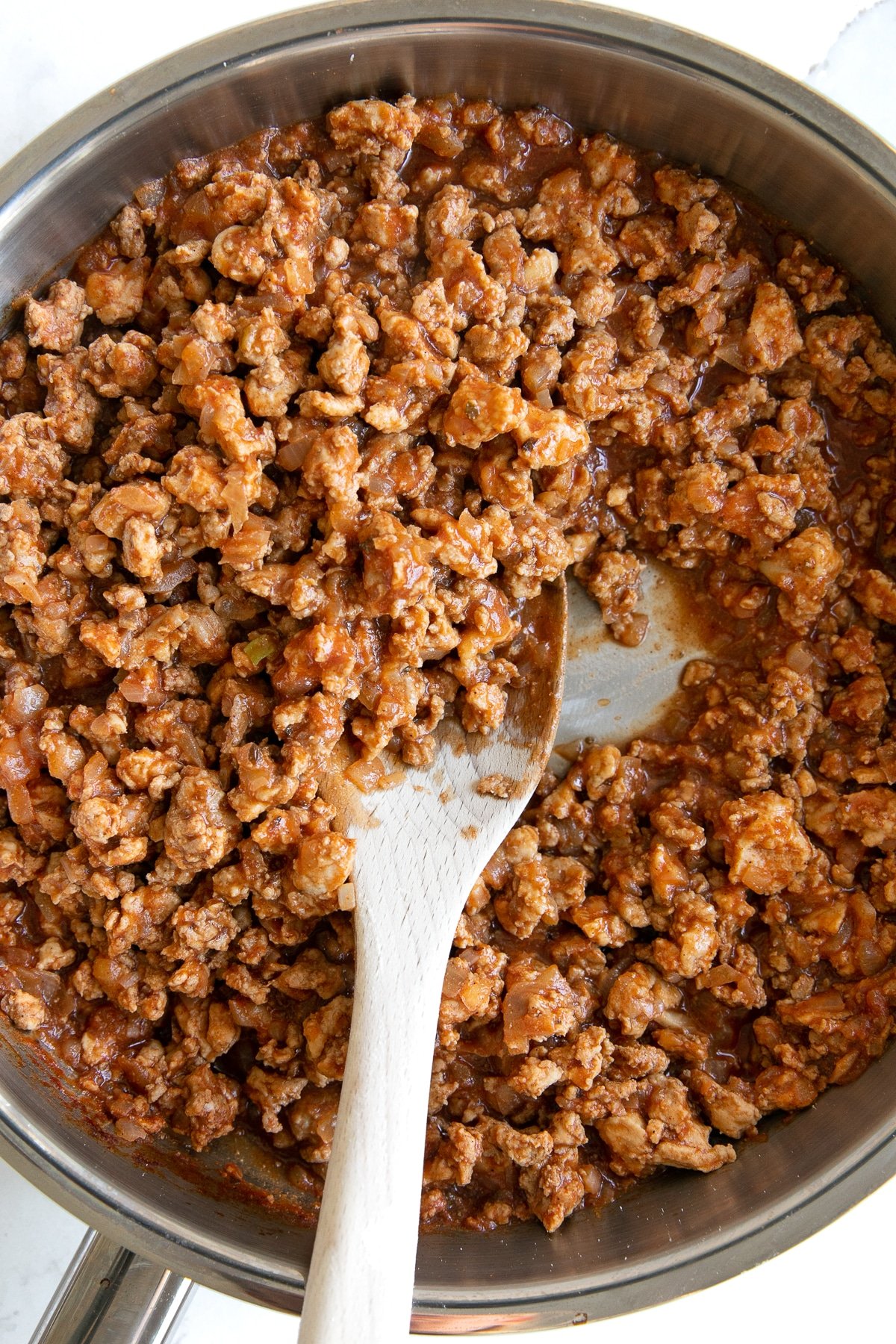 Overhead image of a saucepan filled with ground turkey taco meat.