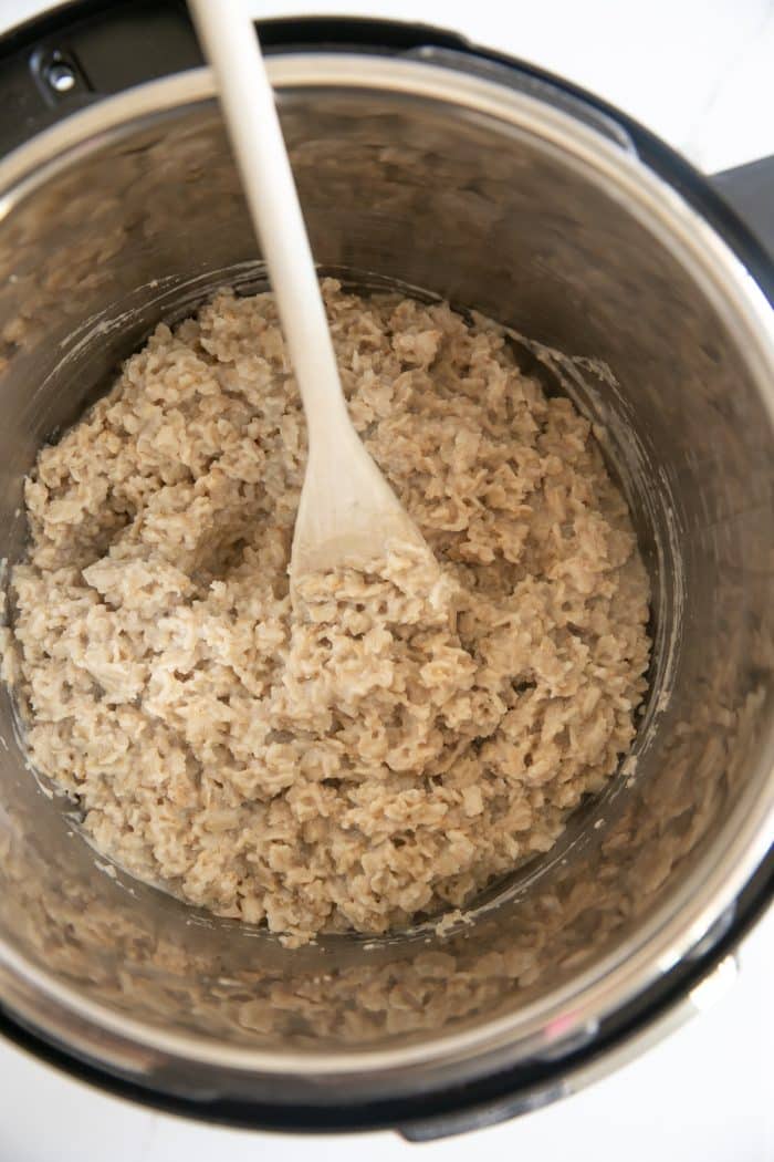 Overhead image of a large Instant Pot filled with cooked oatmeal made with rolled oats and water.