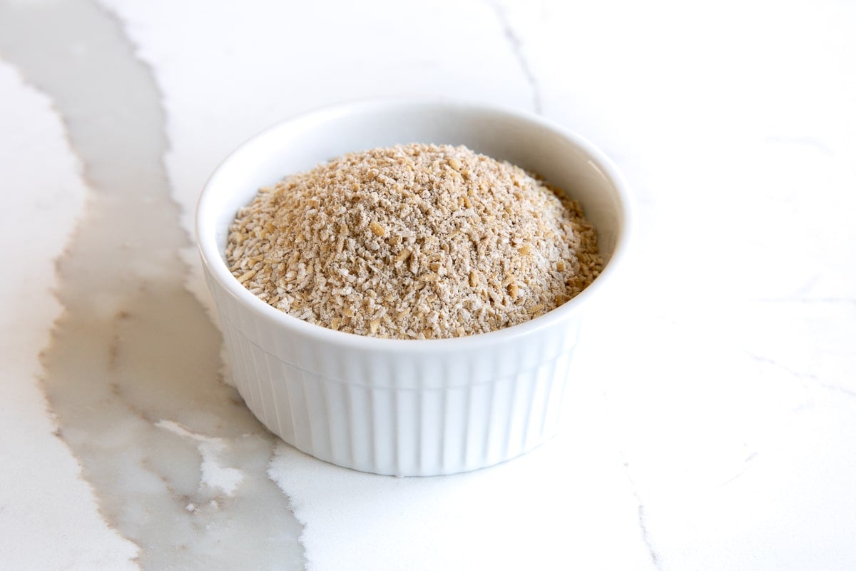 Image of a small white ramekin filled with Scottish oats.