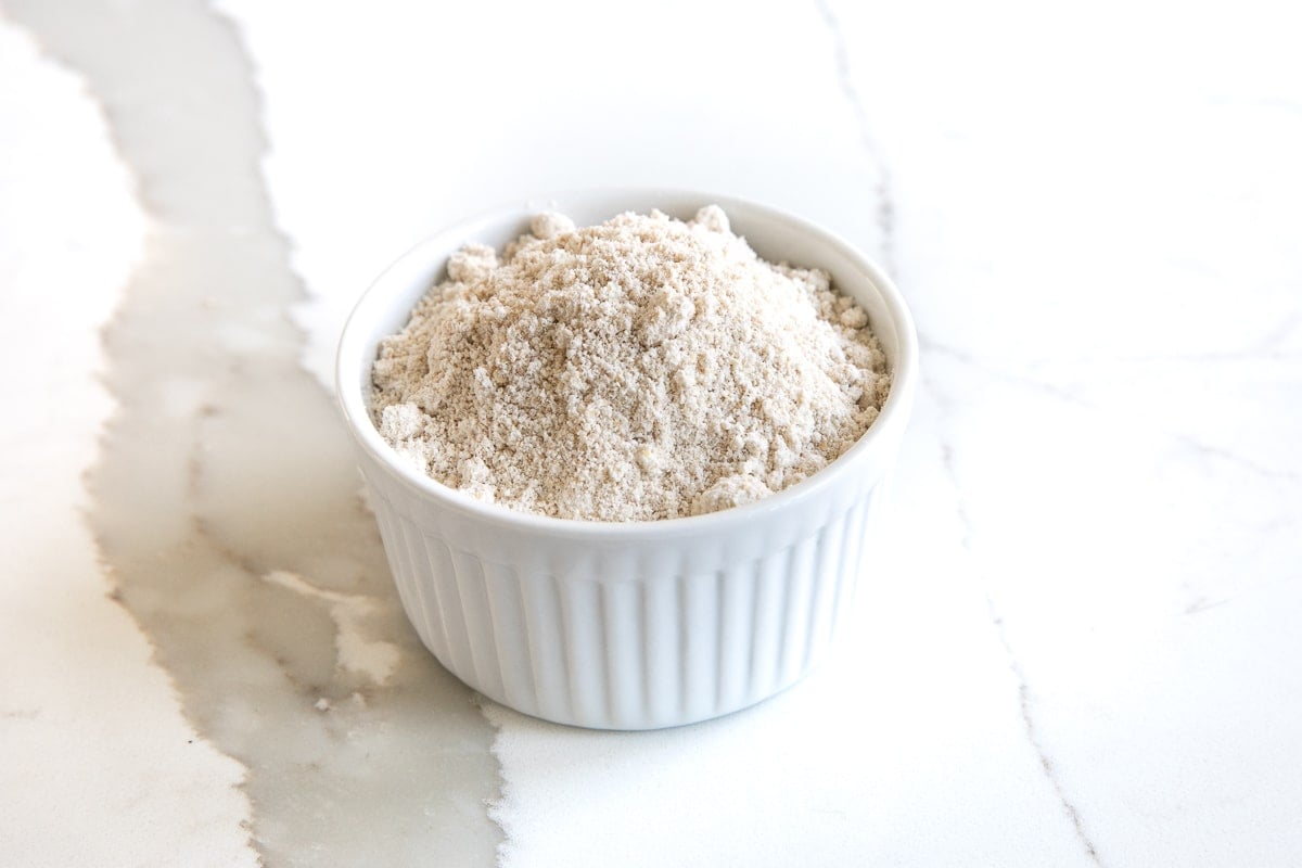 Image of a small white ramekin filled with oat flour.
