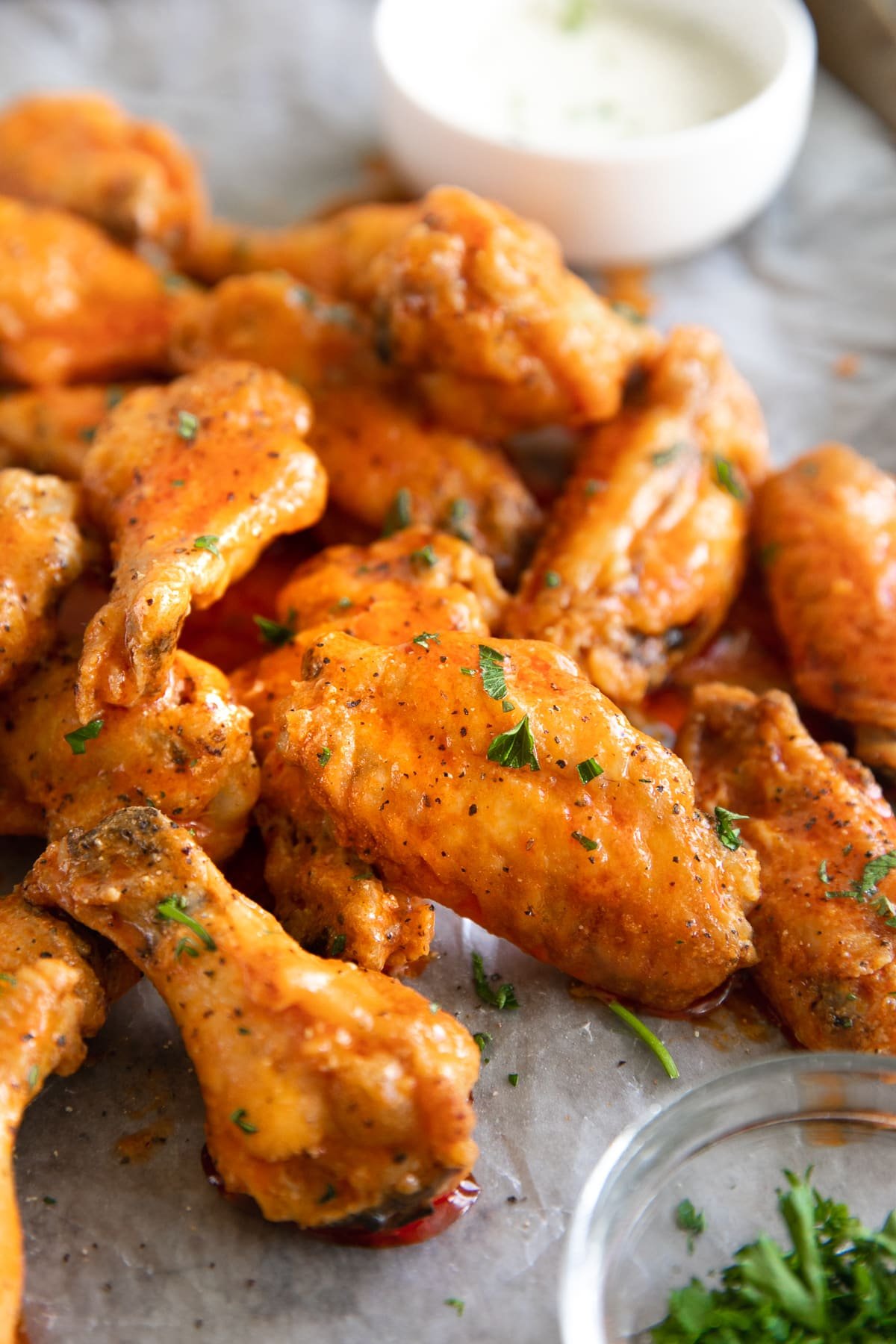 Close up image of buffalo chicken wings covered in buffalo sauce.