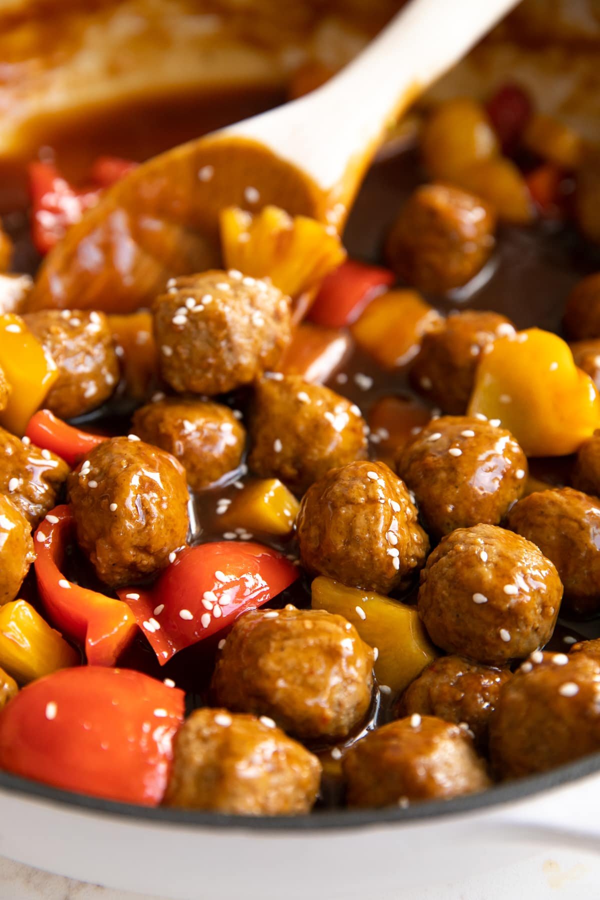 Close up image of a pan filled with sweet and sour meatballs.
