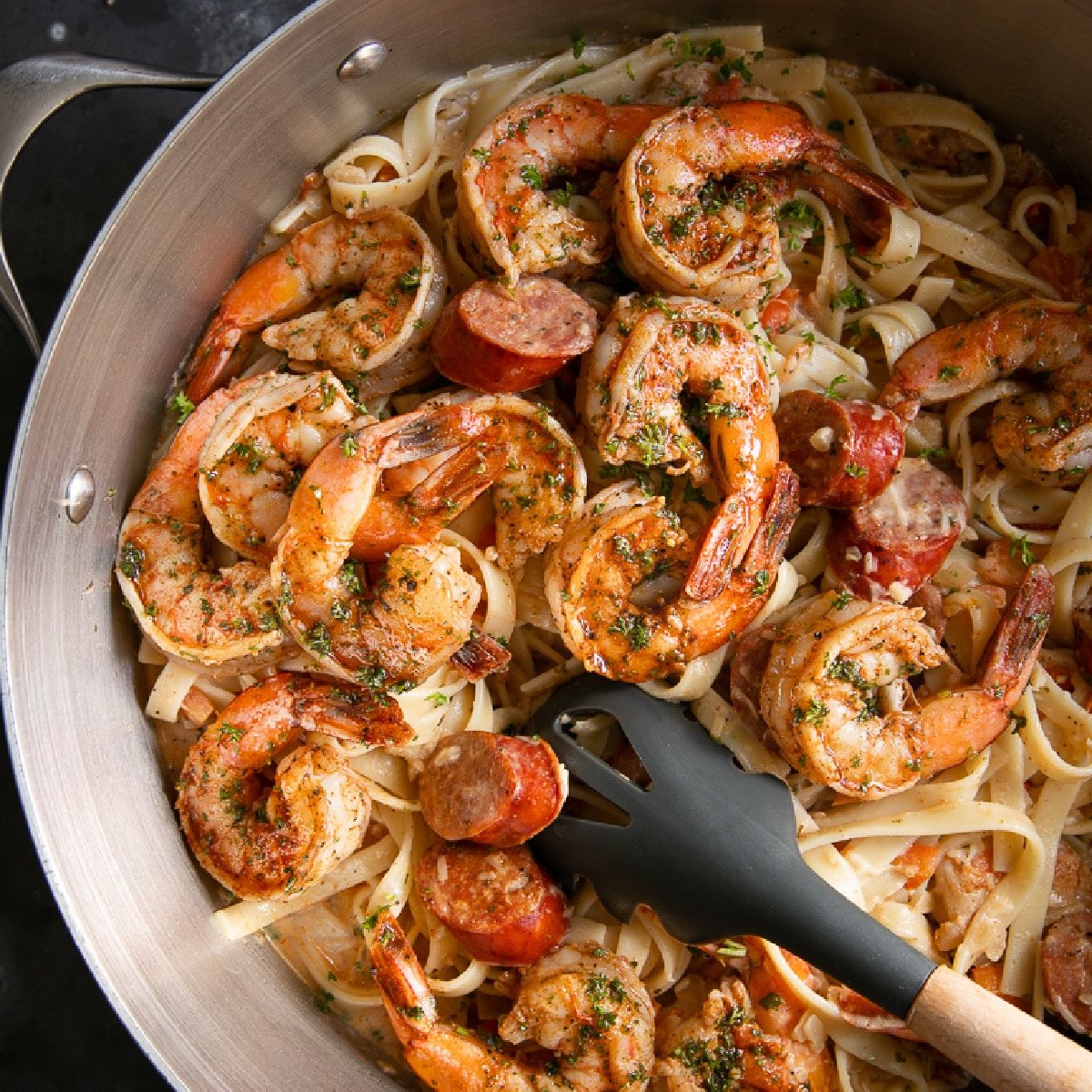 Large pot filled with creamy Cajun alfredo pasta topped with juicy Cajun seasoned cooked shrimp.