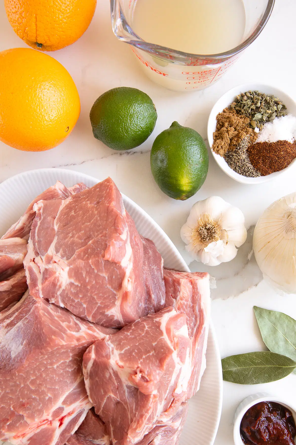 Ingredients needed to make pork carnitas (Mexican pulled pork).
