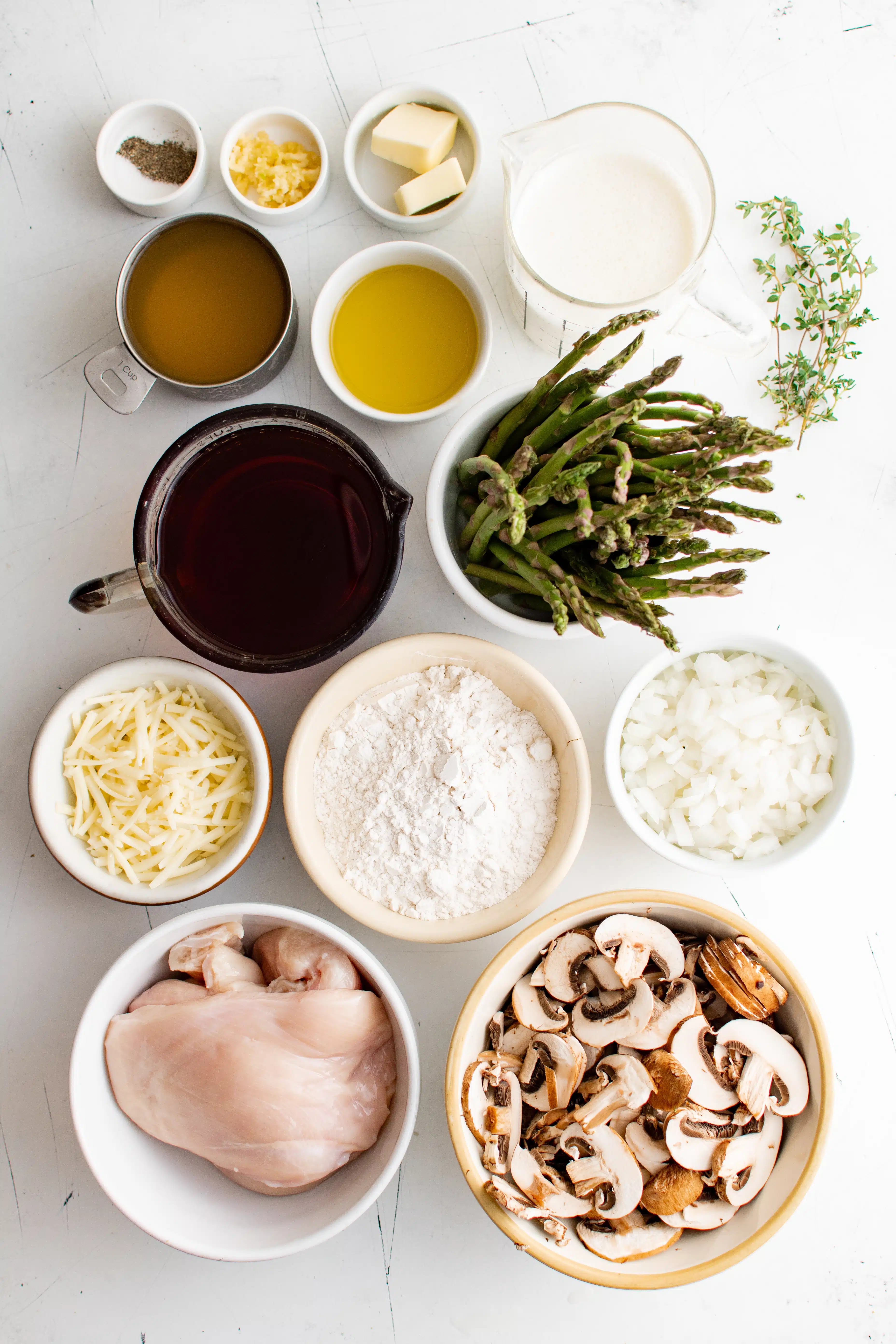 Ingredients needed to make creamy chicken madeira set aside in small serving dishes.