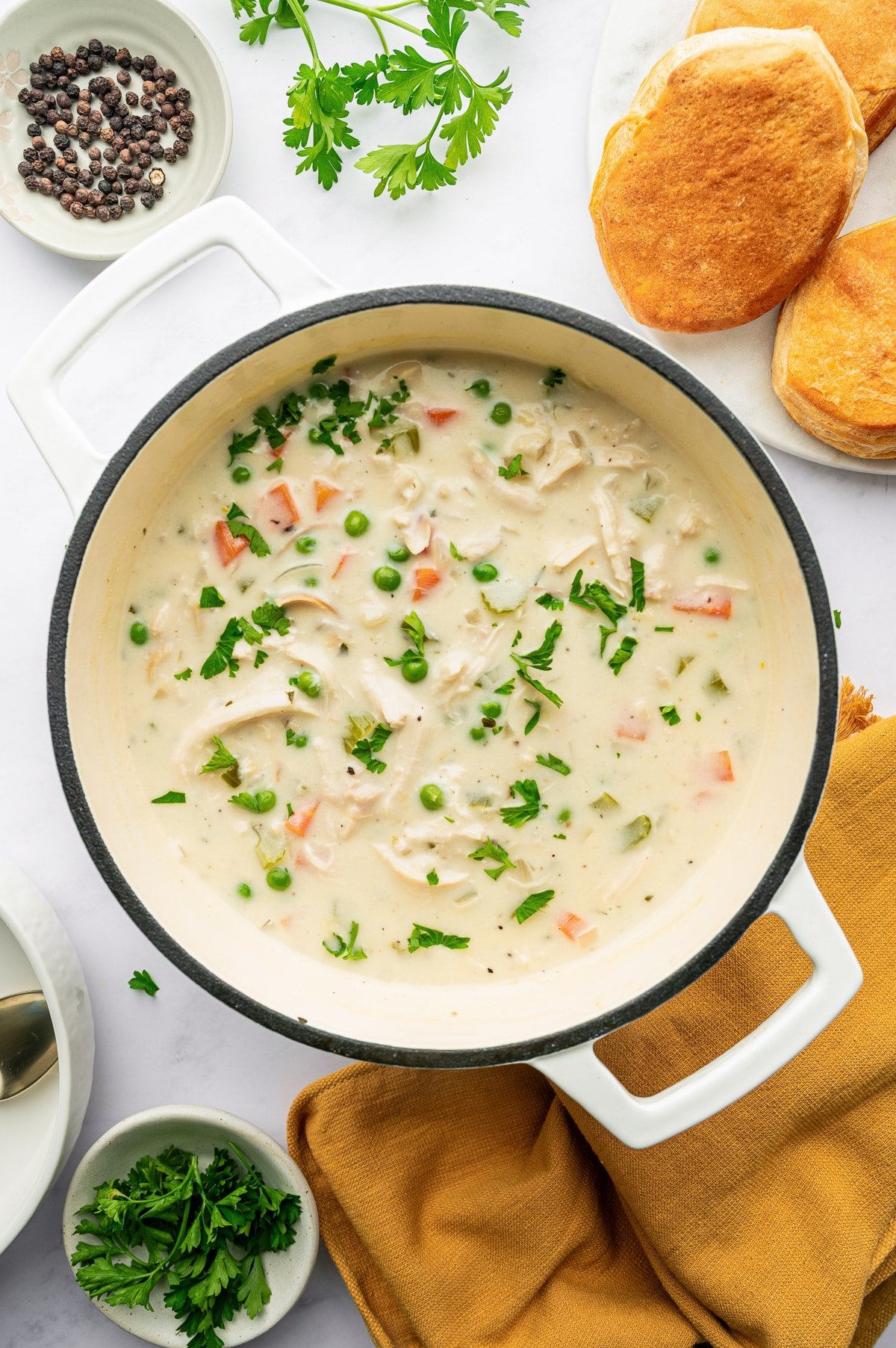 Finished creamy Chicken Pot Pie Soup in a Dutch oven topped with fresh parsley.
