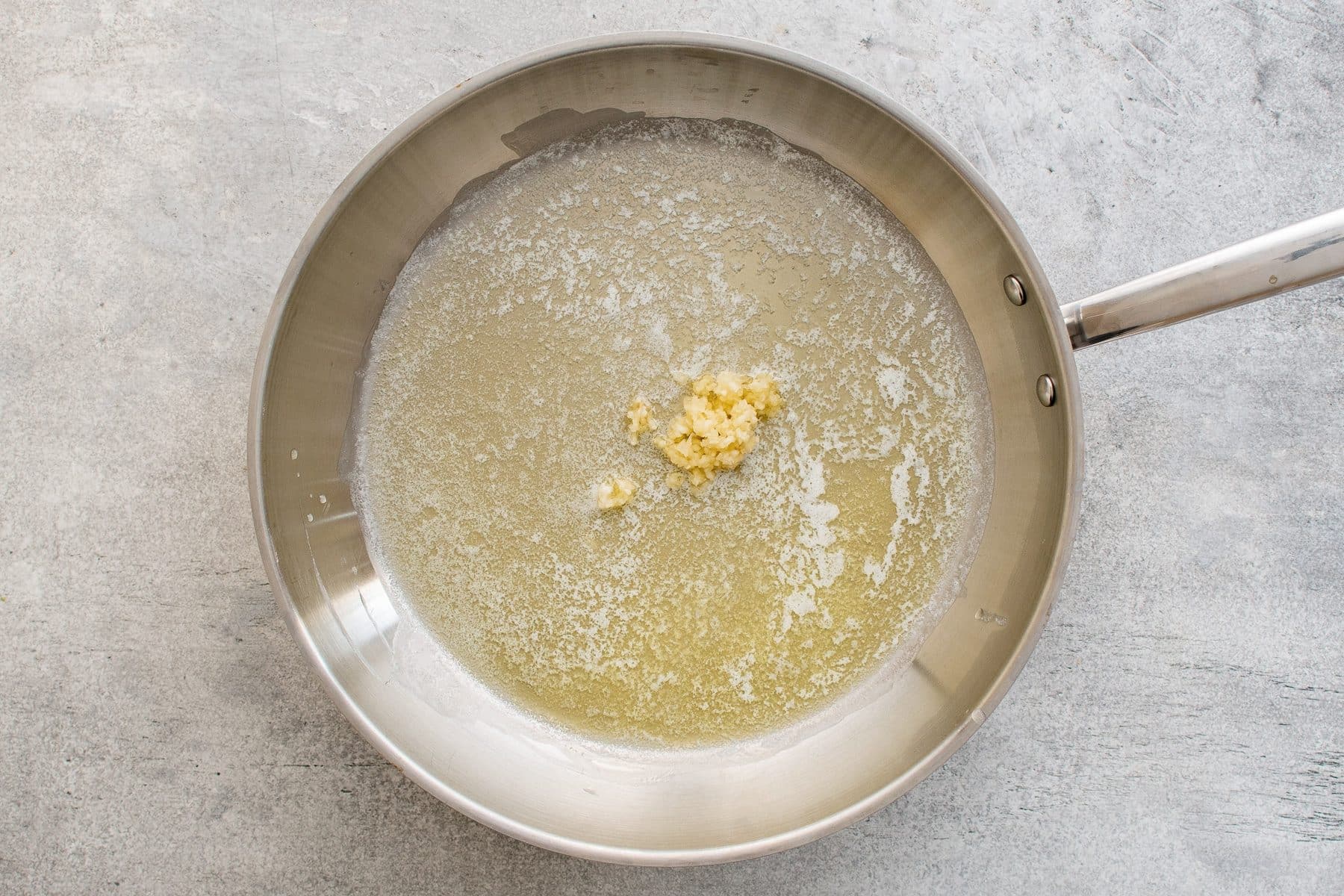 Melted butter and minced garlic in a large skillet.