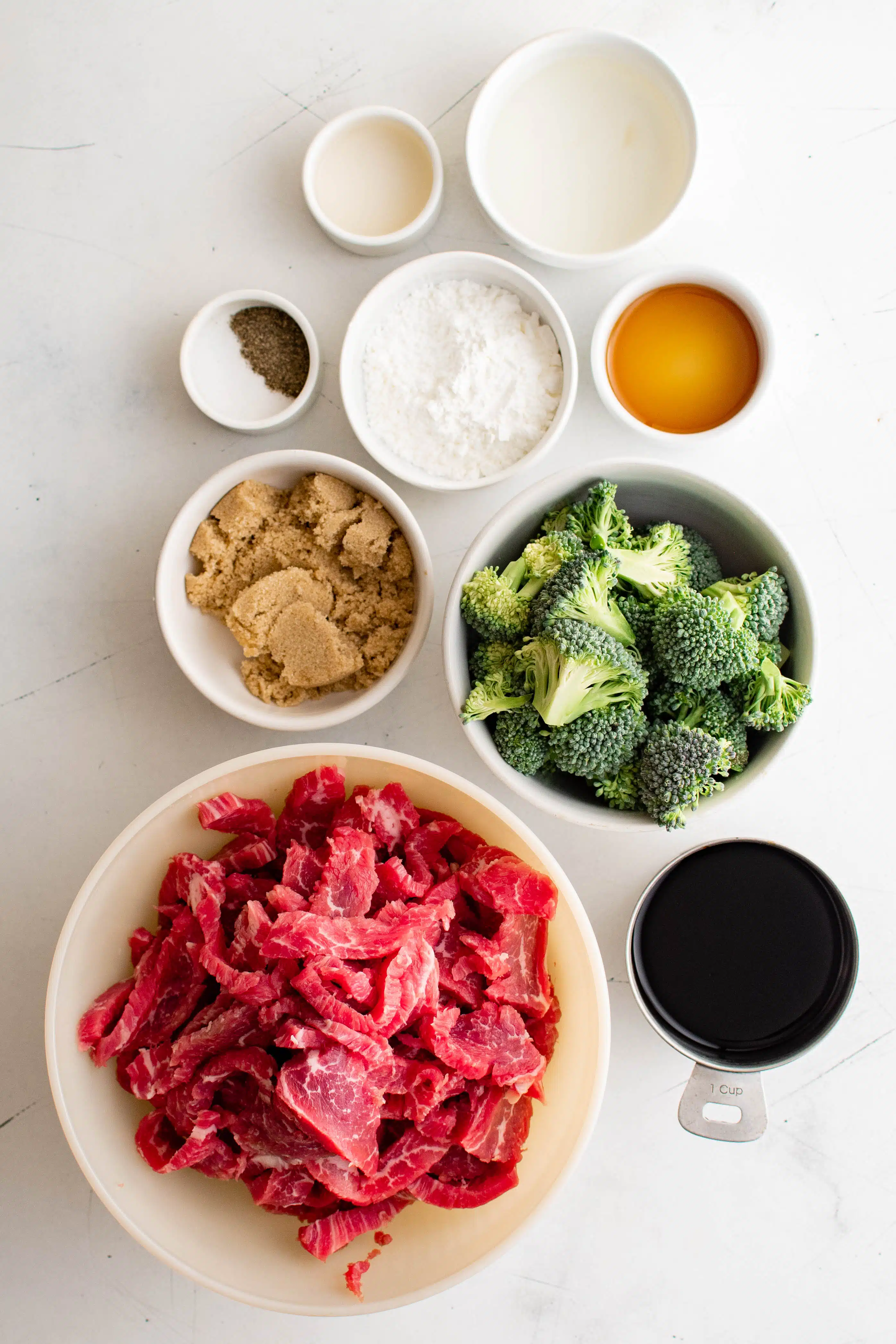 Ingredients needed to make Beef and Broccoli Recipe set aside in individual serving bowls.