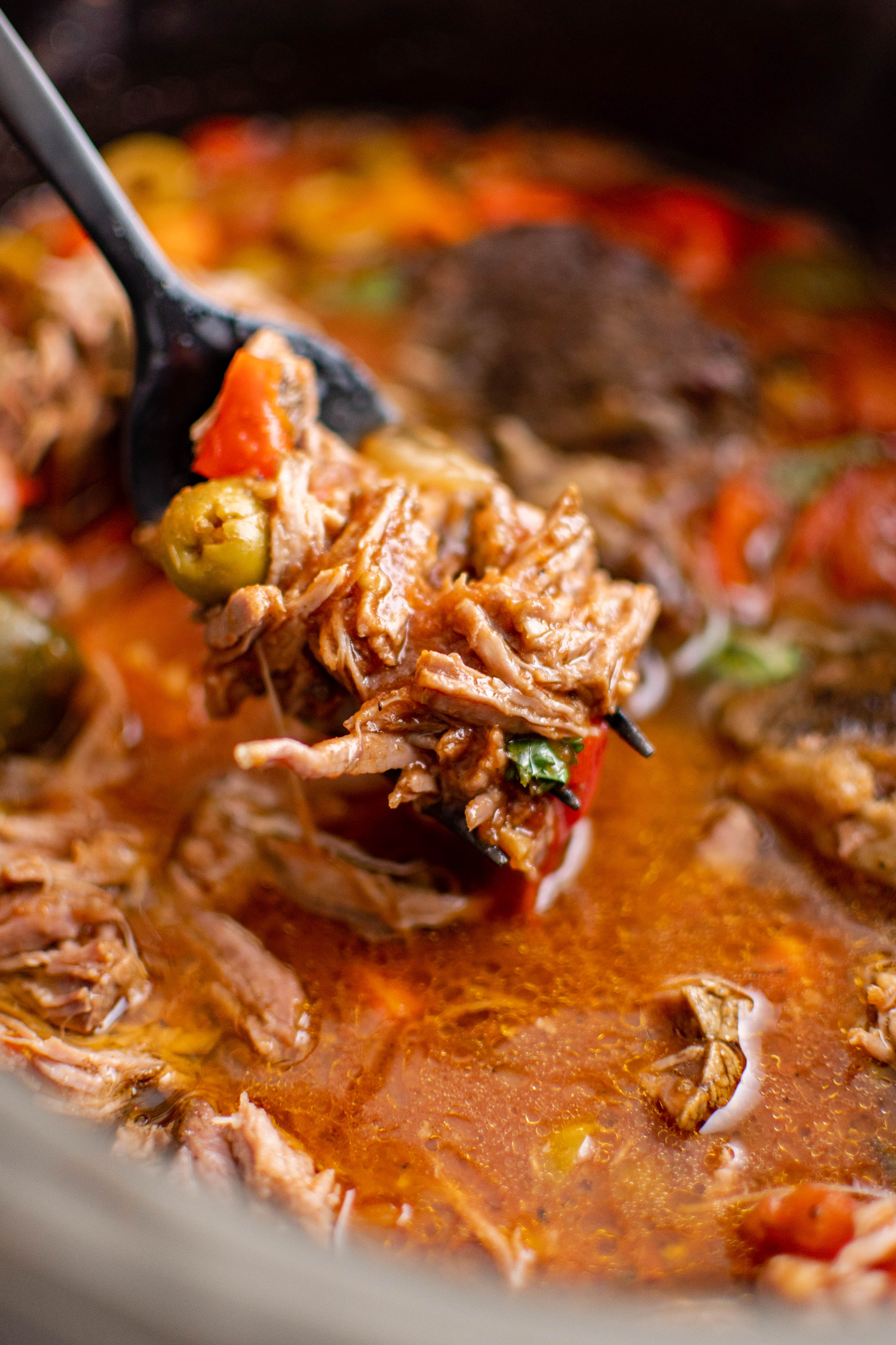 A close up image of fully cooked slow cooker pot roast with picadillo.