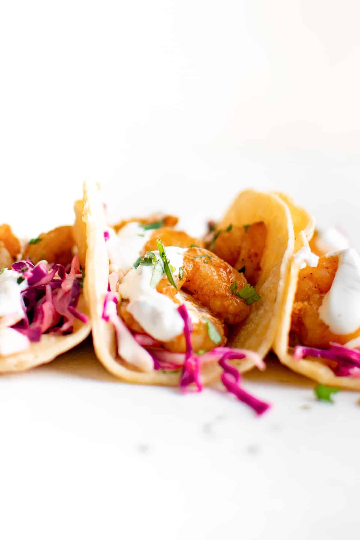 Corn tortillas topped with cabbage slaw, shrimp, and creamy shrimp taco sauce.