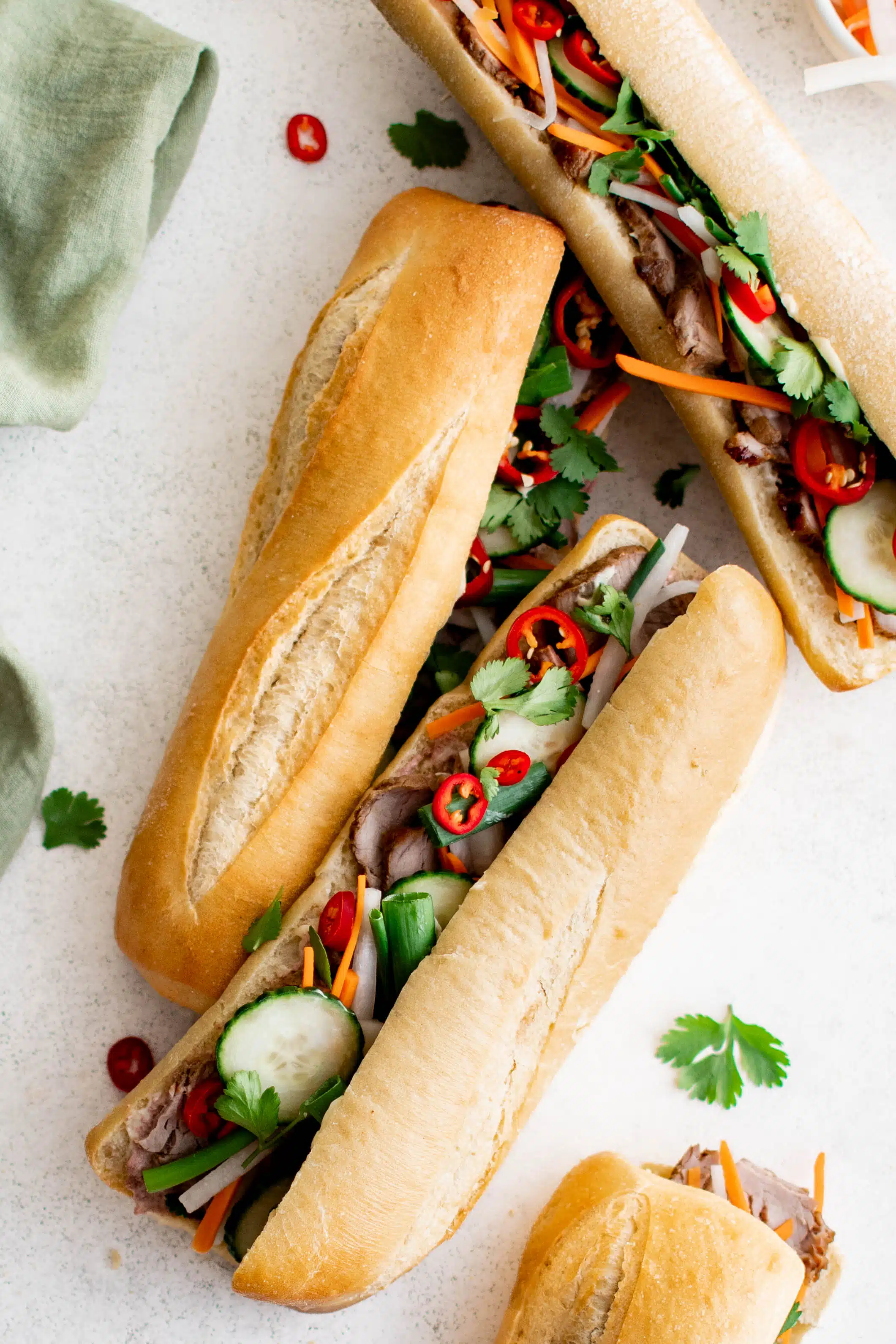 Three Bánh Mì sandwiches assembled and ready to serve.