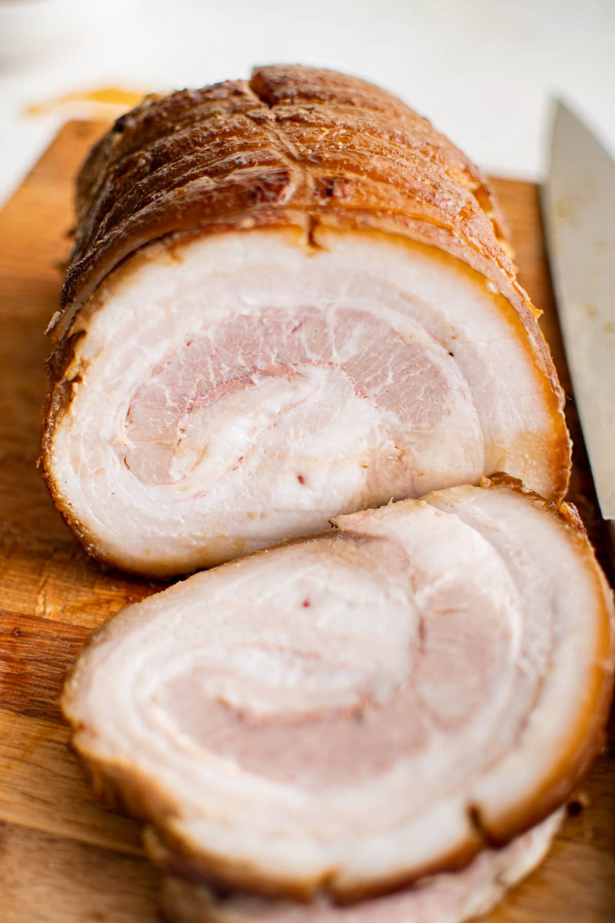 Thinly sliced chashu pork on a large cutting board.