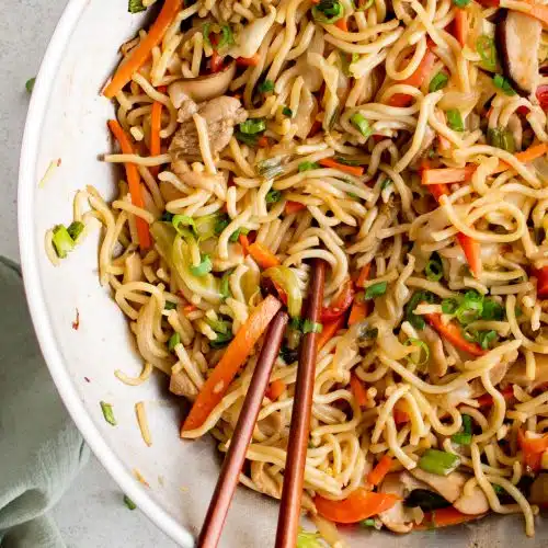 Large wok filled with yakisoba noodles, chicken, and veggies covered in yakisoba sauce.