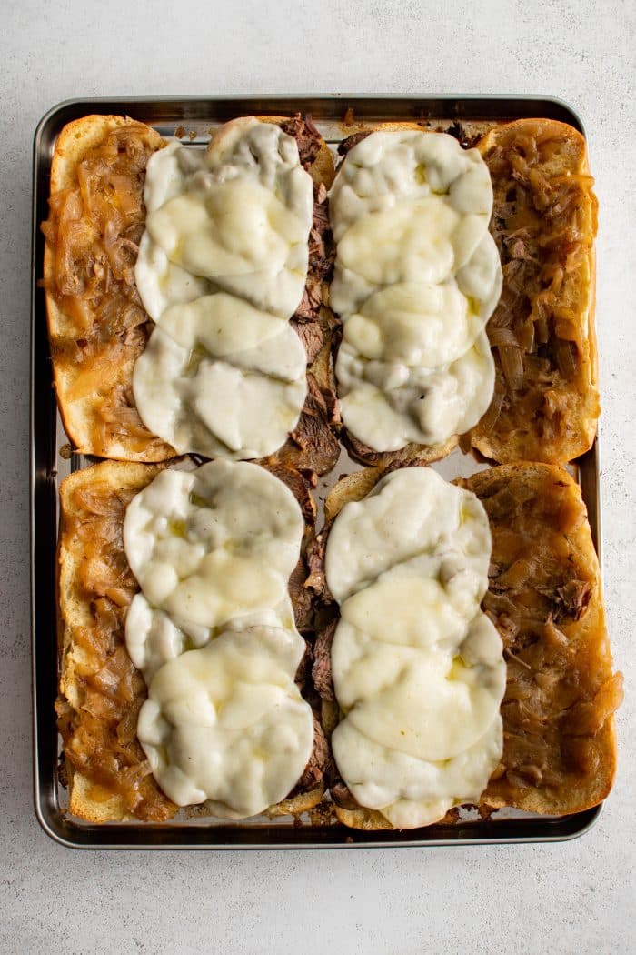 Four toasted and sliced French rolls topped with sliced chuck roast, cooked onions and au jus, and sliced melted provolone cheese.