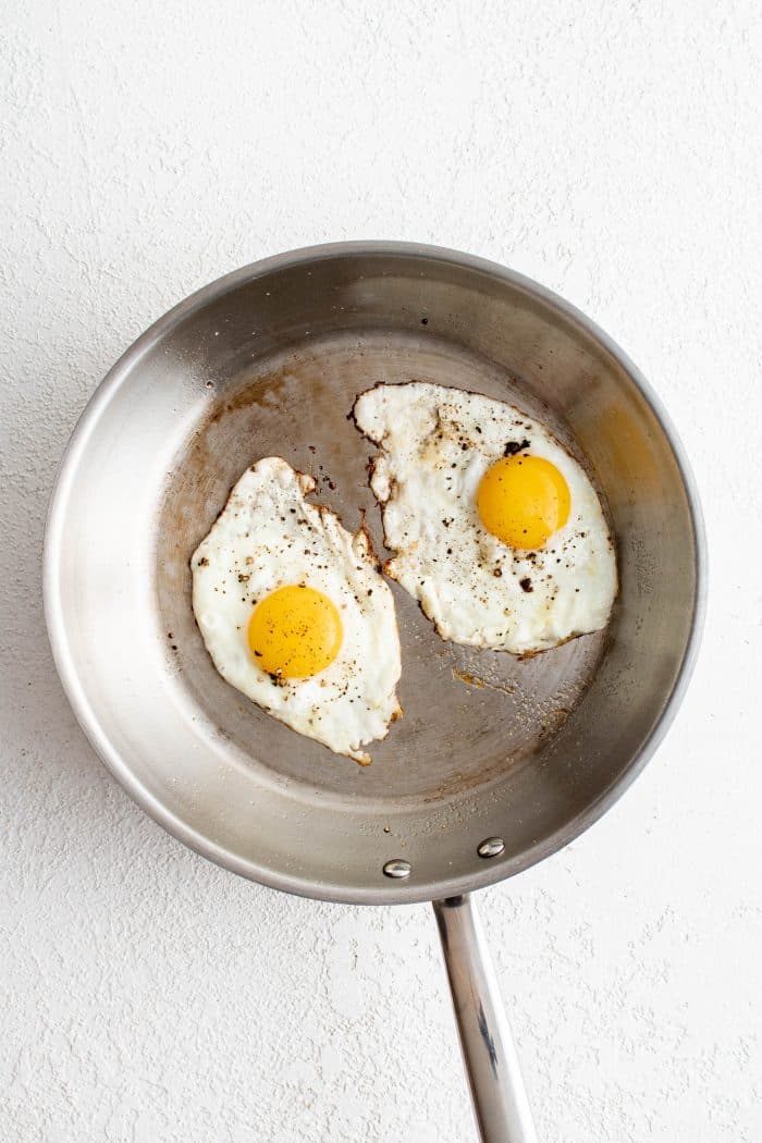 Skillet filled with two perfect fried eggs.