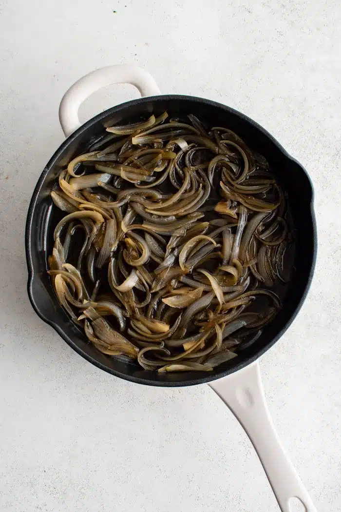Large pan filled with soft and jammy sauteed onions.