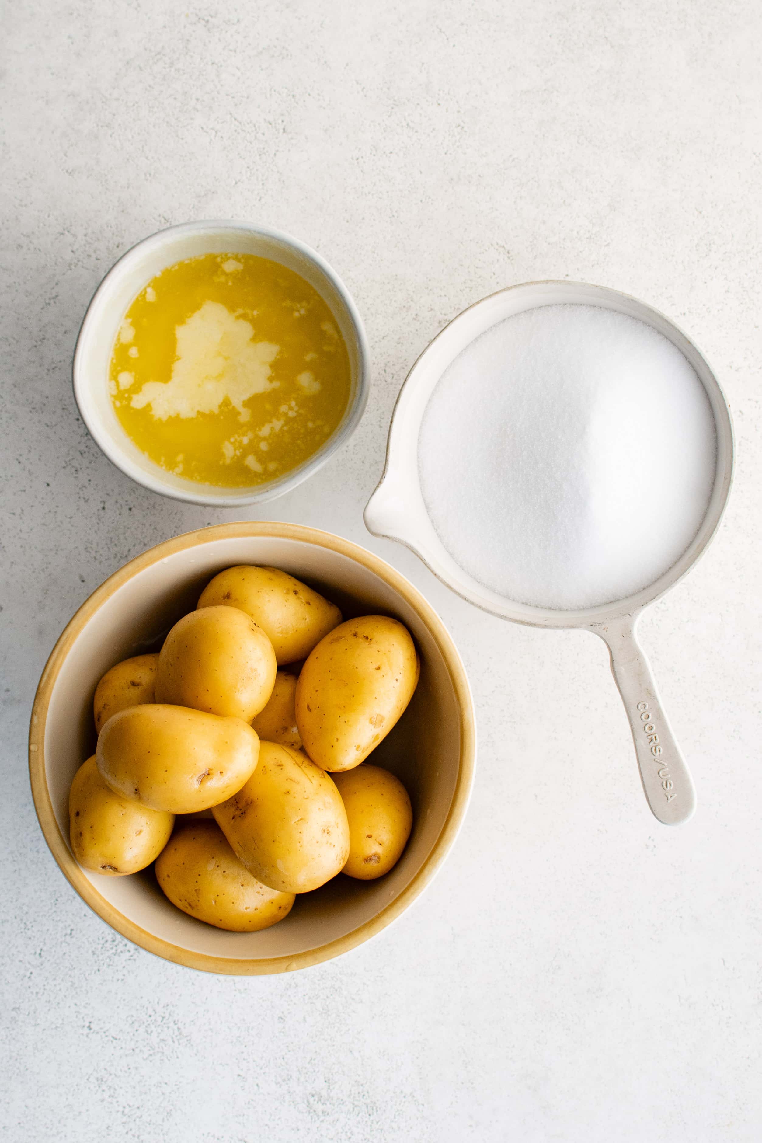 Ingredients needed to make salt potatoes in a bowl in individual measuring cups and ramekins.