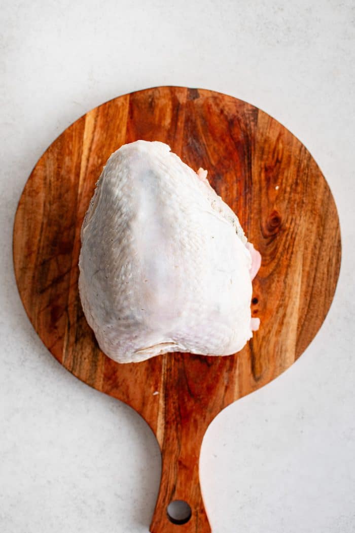 Buttered turkey breast with skin smoothed back into place before roasting.