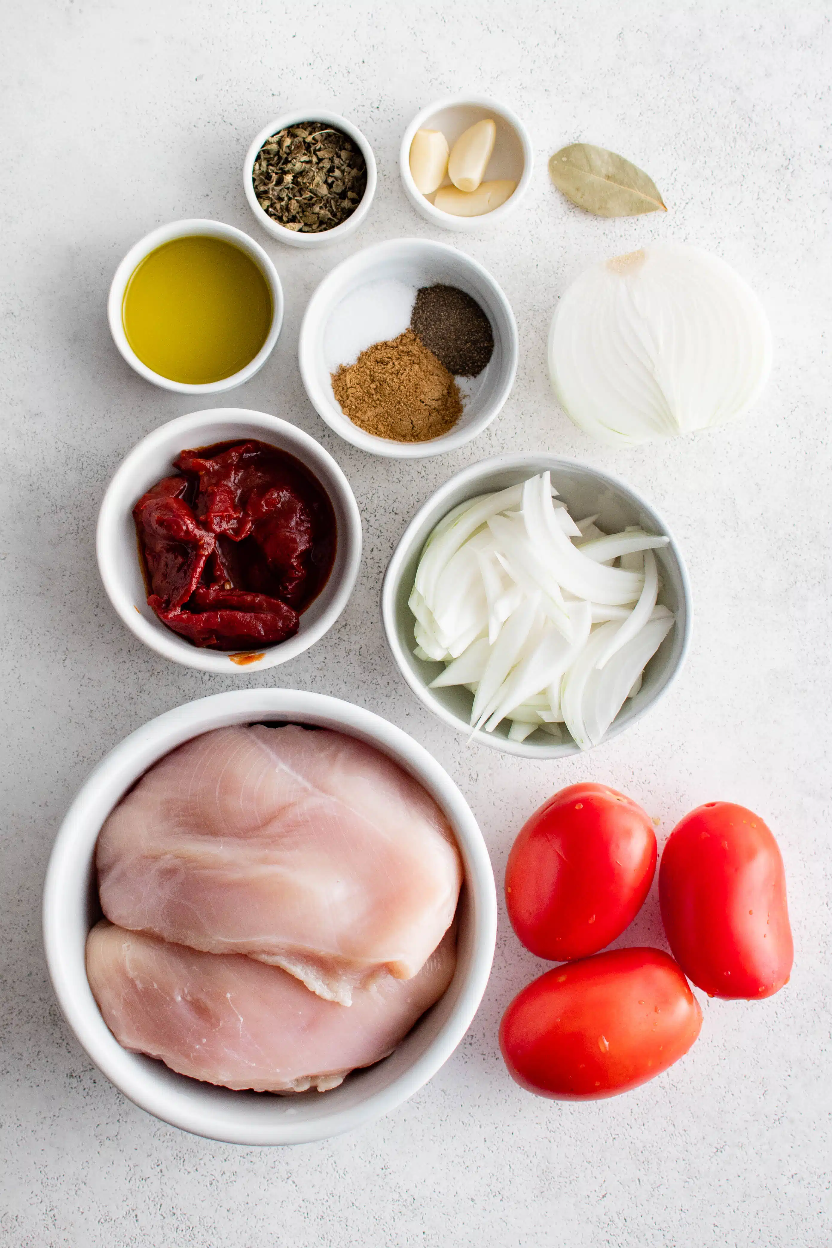 Ingredients needed to make cabbage chicken tinga recipe in individual measuring cups and ramekins.