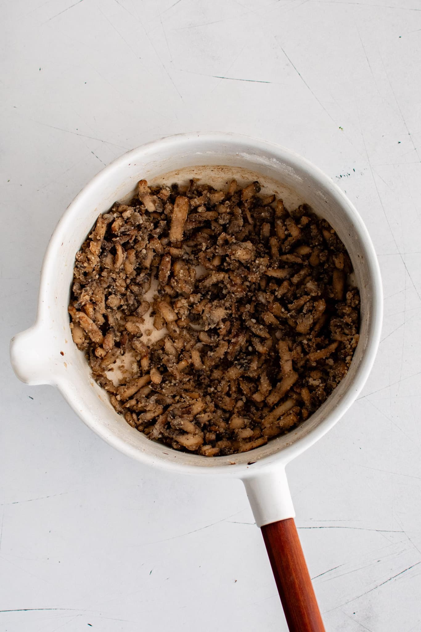 White pot filled with caramelized diced mushrooms coated in all-purpose flour, garlic powder, onion powder, black pepper and salt.