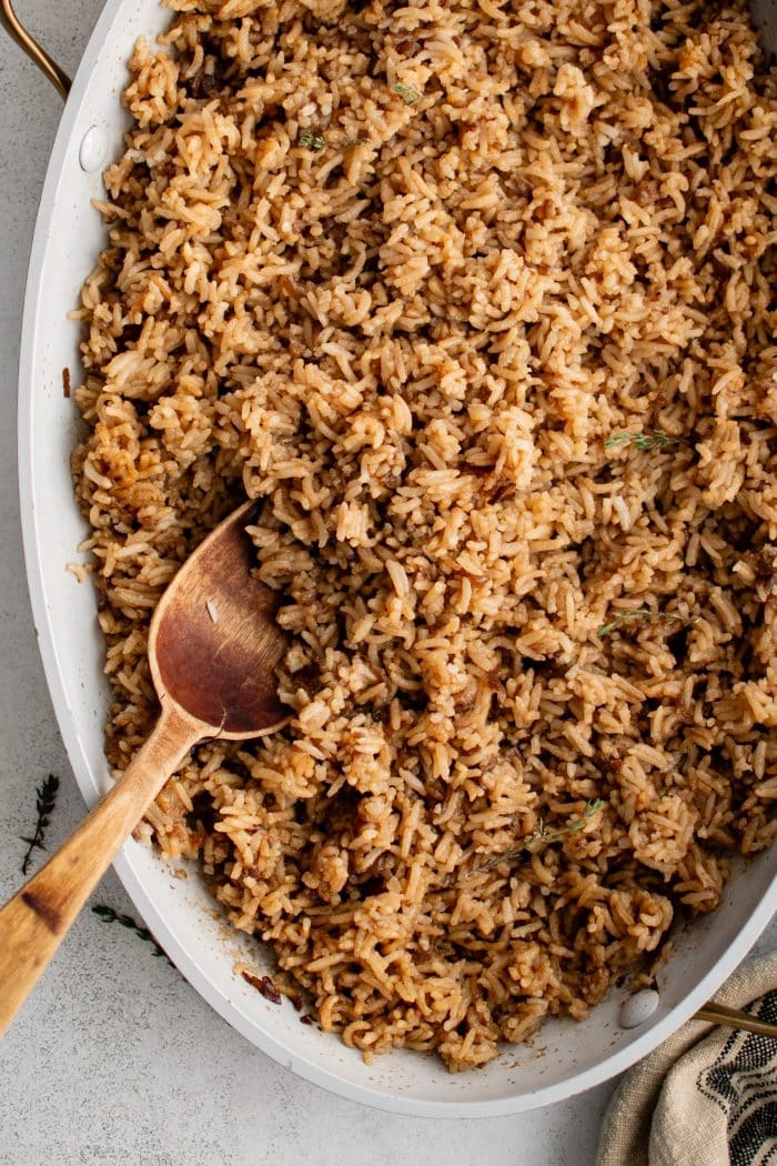 Flavorful and buttery Stick of Butter Rice filling a large oval-shaped casserole dish.