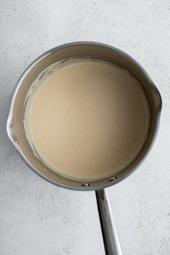 Small sauce pot filled with honey mustard sauce.