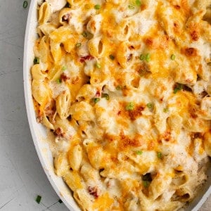 Baked crack chicken with golden gooey melted cheese on top in a large oval baking dish.