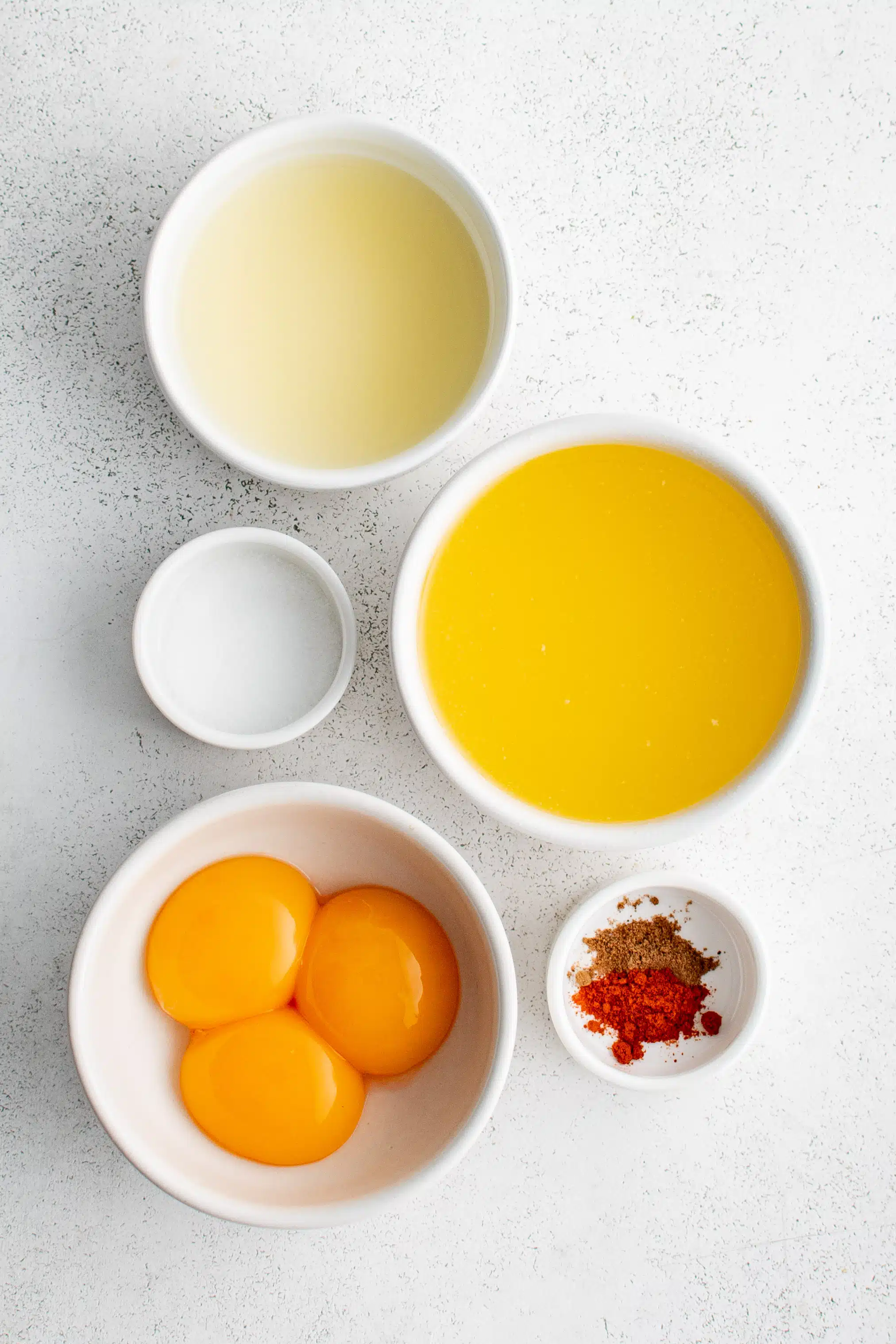 Ingredients for Hollandaise Sauce in individual measuring cups and ramekins.