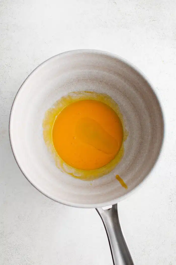 Three whisked eggs in a medium saucepan.