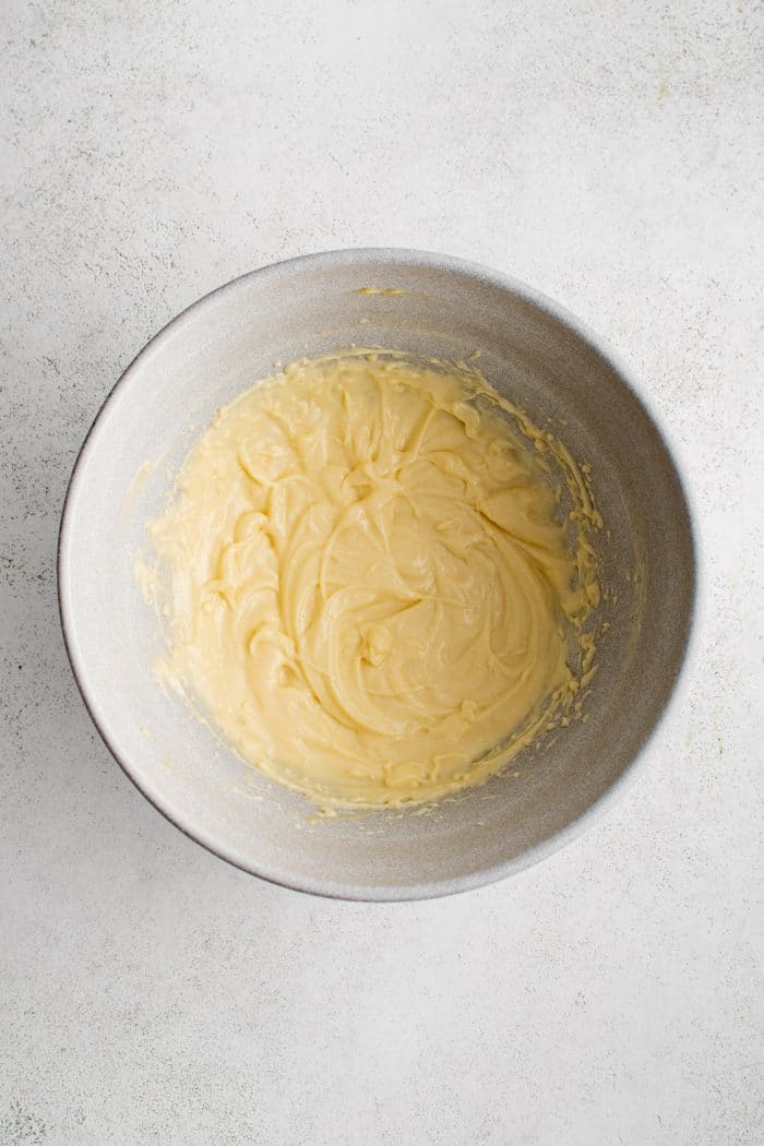 Medium mixing bowl filled with whipped and creamy homemade mayonnaise.