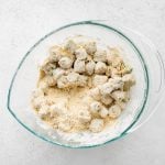 Okra coated in buttermilk and dredged in a mixture of all-purpose flour, cornmeal, garlic powder, onion powder, salt, pepper, and paprika.