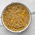 1-inch pieces of okra deep frying in a large deep-frying skillet.