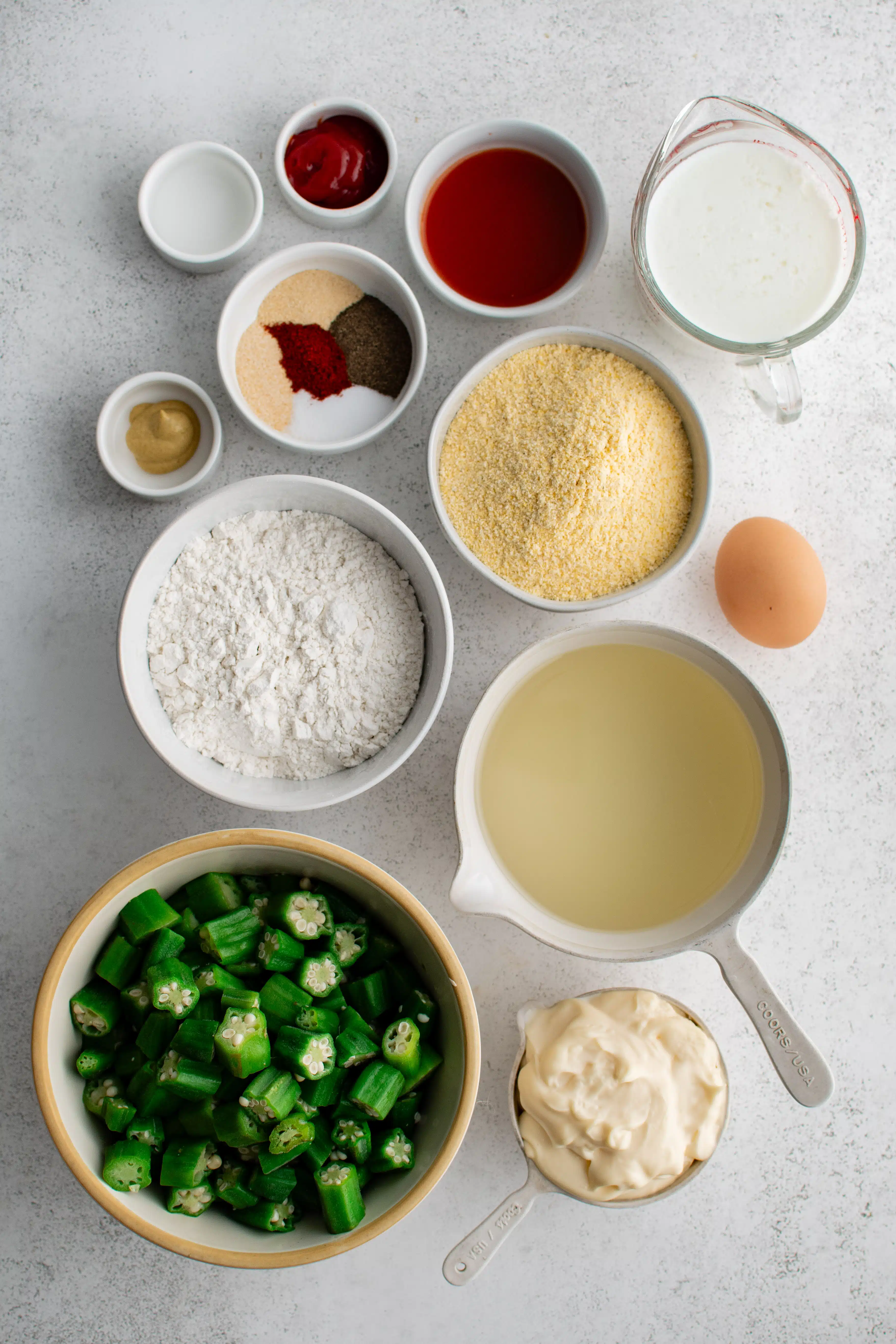 Ingredients in fried okra in individual measuring cups and ramekins.