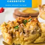 A close-up of a golden slice of sausage and egg breakfast casserole on a white plate with parsley garnish and orange juice in the background, labeled as a super easy make-ahead recipe.