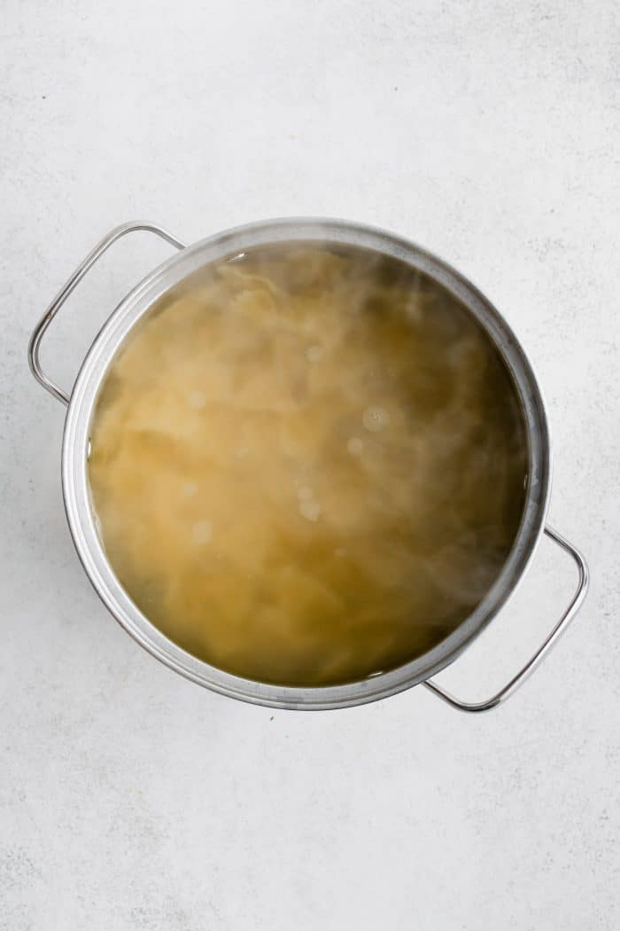 Bowtie pasta boiling in a large pot.