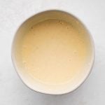 Large bowl filled with creamy lemon dijon dipping sauce.