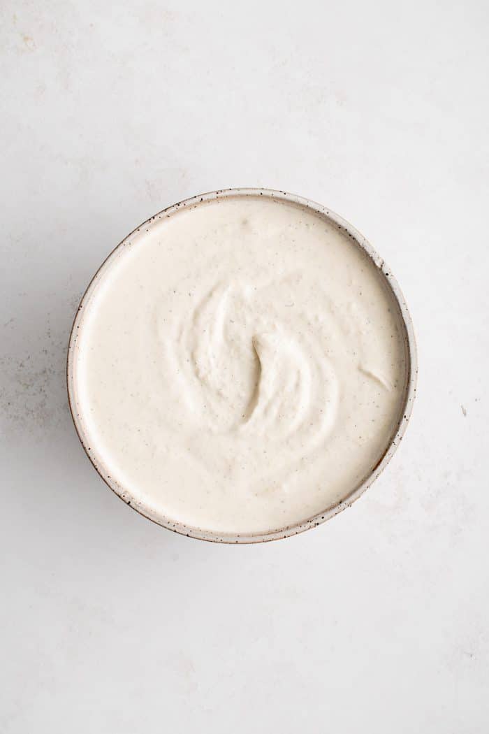 Smooth and creamy homemade horseradish sauce in a white serving bowl.