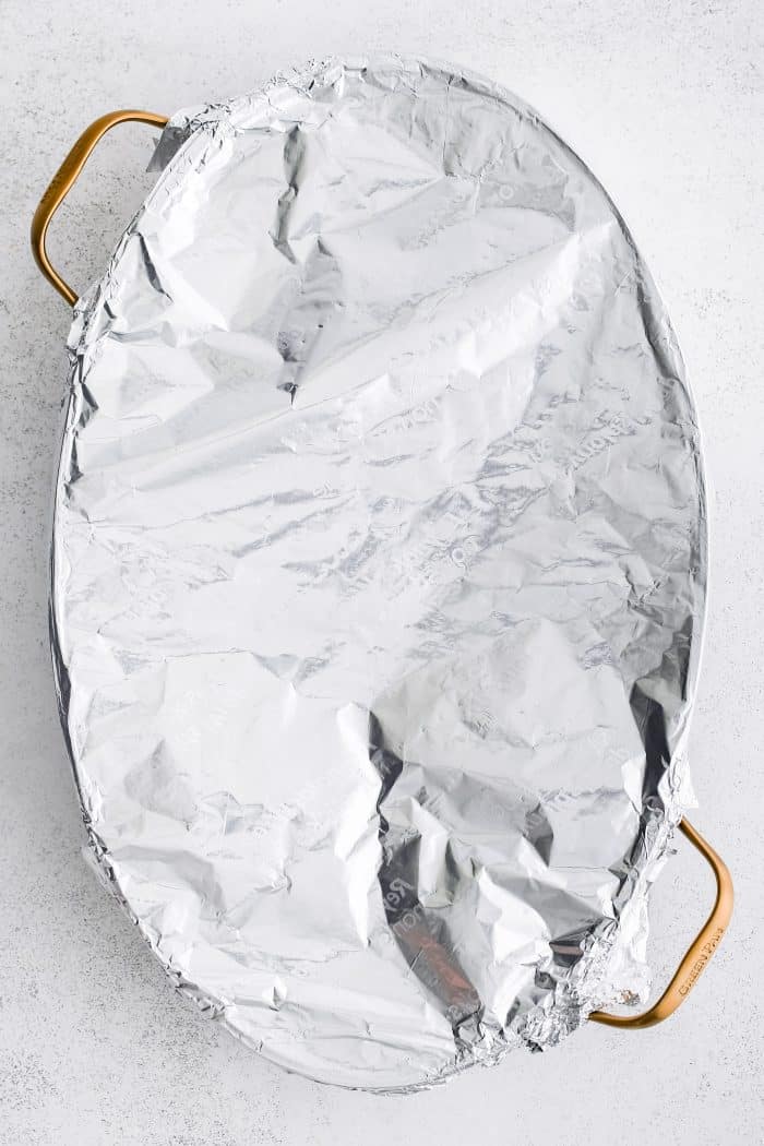 Foil-covered oval-shaped casserole dish.