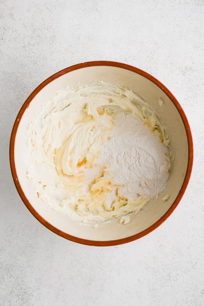 MIxing bowl filled with softened beat cream cheese and vanilla instant pudding.