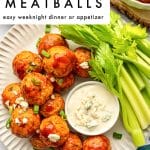 Vertical Pinterest pin image with a white text box at the top and a plated buffalo chicken meatball photo below. The photo shows glossy buffalo chicken meatballs on an off-white ridged plate with celery sticks, sliced green onion garnish, and a small white ramekin of creamy dip topped with blue cheese crumbles. Black text overlay in the top white box reads โBUFFALO CHICKEN MEATBALLSโ with smaller text โeasy weeknight dinner or appetizer.โ The words โthe forked spoonโ appear near the bottom of the pin.