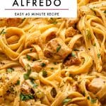 Vertical Pinterest pin for Cajun Chicken Alfredo featuring a close-up photo of creamy fettuccine Alfredo with browned chicken pieces, diced vegetables, chopped parsley, and black pepper. At the top is a large light gray text box with black capital letters reading CAJUN CHICKEN ALFREDO and smaller text below reading EASY 40 MINUTE RECIPE, separated by a mauve horizontal line. The words the forked spoon appear at the bottom.