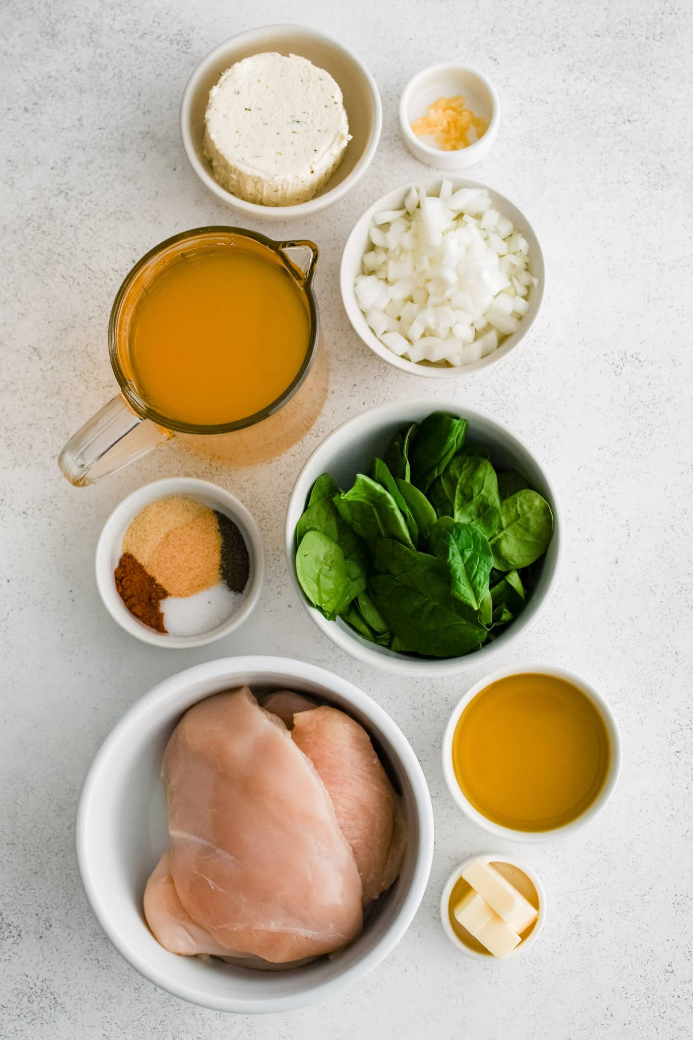 All of the ingredients needed to make creamy boursin chicken in individual measuring cups and ramekins.