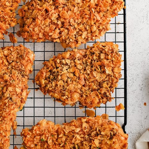 Wire cooking rack topped with chicken coated in a seasoned corn flake crust and cooked until perfectly crisp!