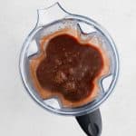 Homemade chile colorado sauce in a large blender before being strained through a fine mesh strainer.